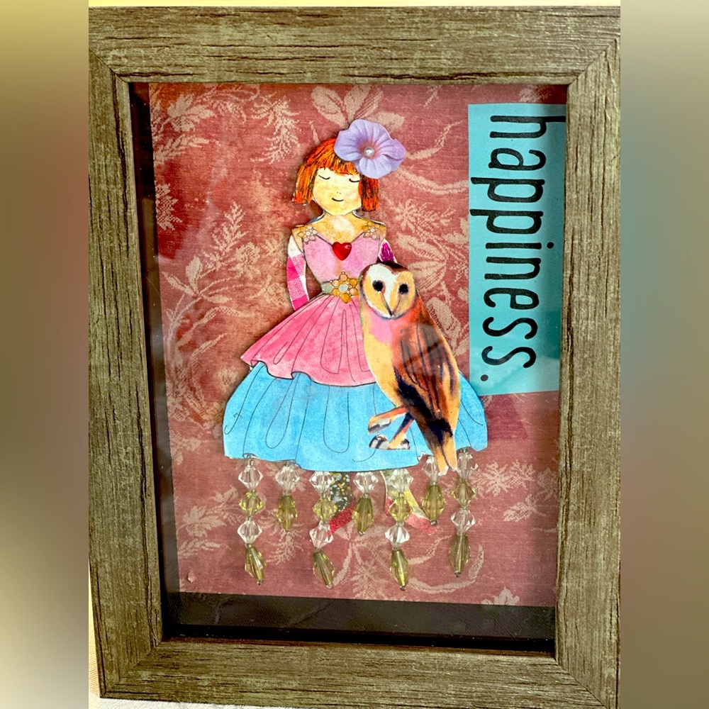 Happiness paper doll in shadow box.